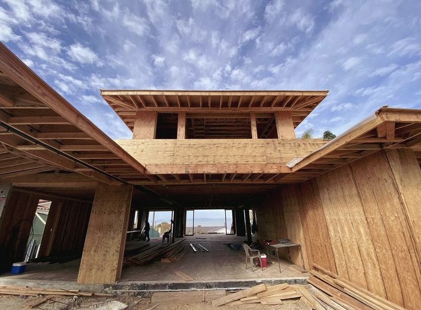 Large custom home framed with deep roof overhangs